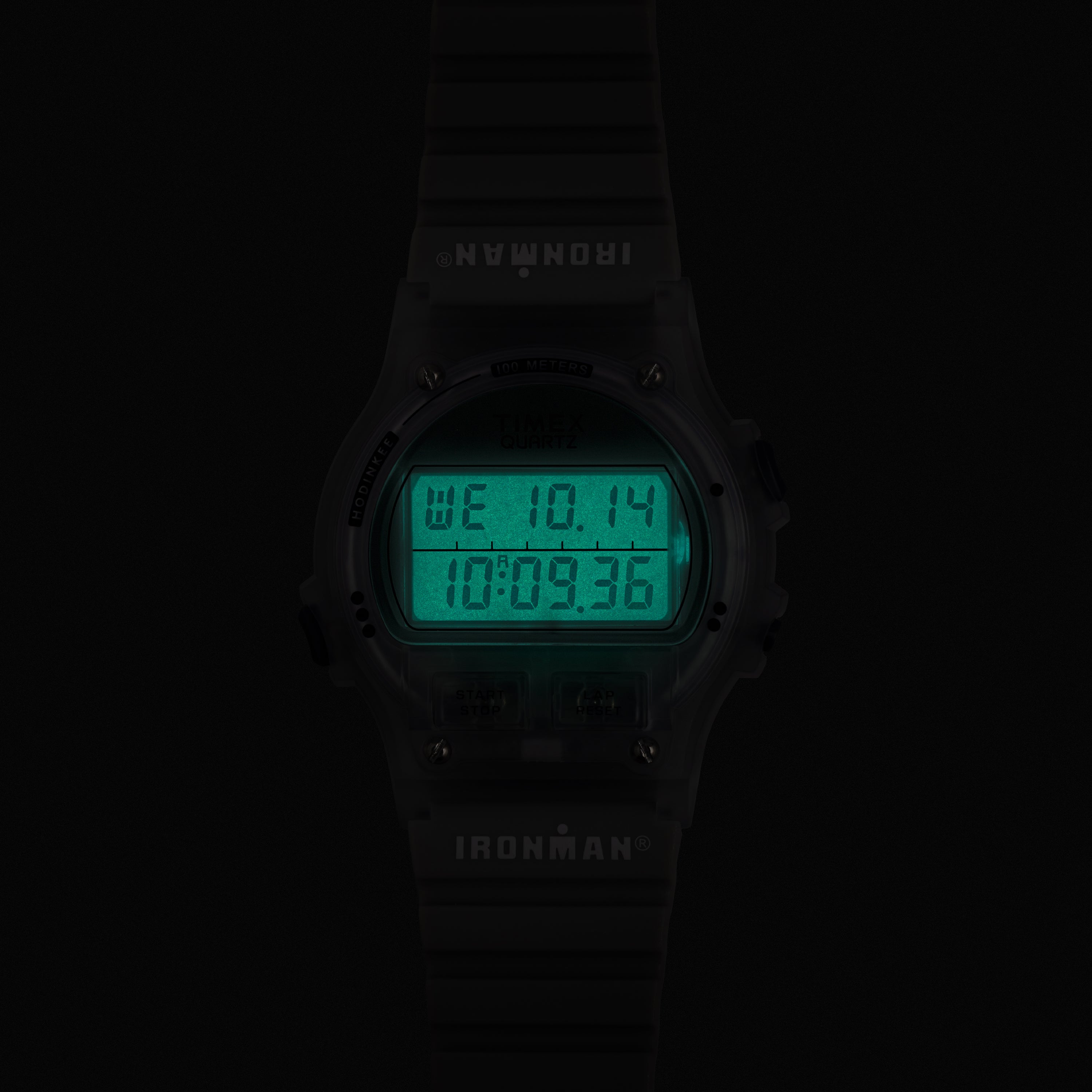 Digital watch with green display on a black background