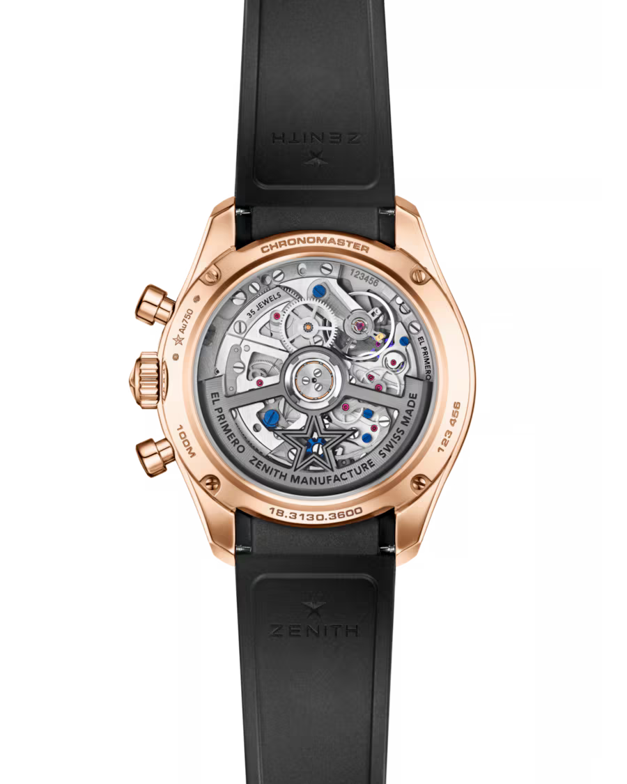 Rose gold chronograph watch with exposed movement visible through transparent caseback and black rubber strap.
