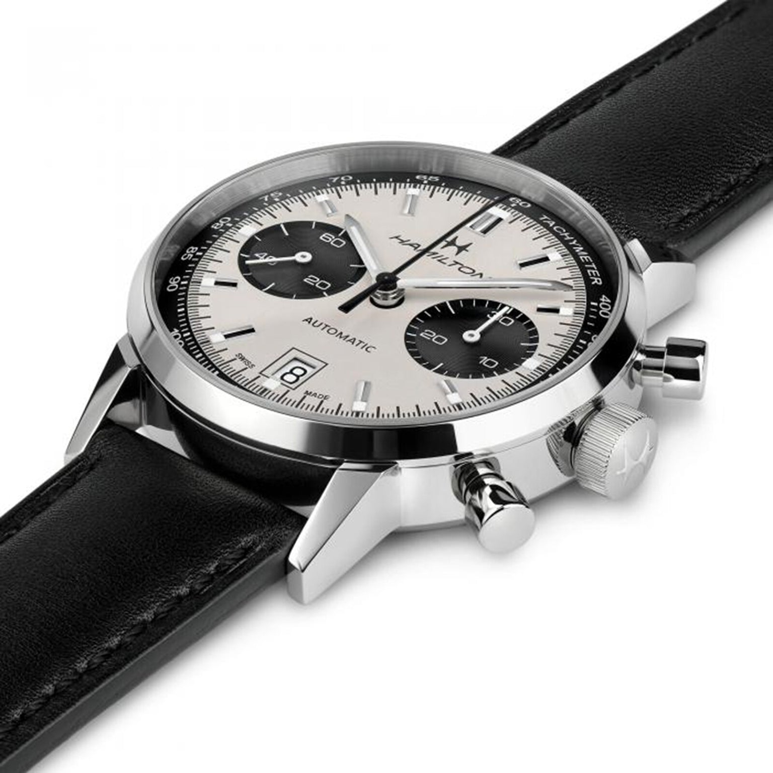 The Hamilton American Classic Intra-Matic Auto Chrono is a silver and black chronograph wristwatch featuring a leather strap, date display, and three subdials.