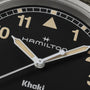 Close-up of the Hamilton Khaki Field Quartz watch face, displaying the logo, hands, and numbers 10, 11, and 1.