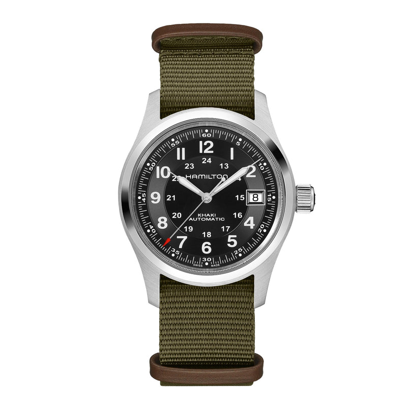 The Hamilton x Call of Duty Black Ops 7 features a round silver case, black dial with white numerals, olive green fabric strap with brown leather accents, Swiss-made movement, 12/24-hour markers, and a date window at 3 o’clock.