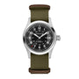 The Hamilton x Call of Duty Black Ops 7 features a round silver case, black dial with white numerals, olive green fabric strap with brown leather accents, Swiss-made movement, 12/24-hour markers, and a date window at 3 o’clock.