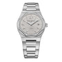 The Girard-Perregaux Laureato 34 is a silver wristwatch with a round, diamond-studded octagonal bezel, textured dial, date display at 3 o’clock, and a metal bracelet.