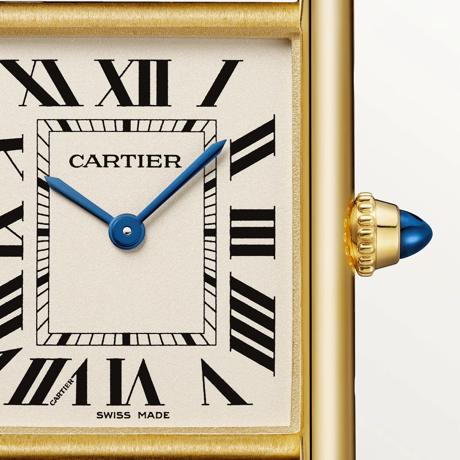 Close-up of a Cartier Tank Louis Medium Model watch face with black Roman numerals, blue sword-shaped hands, gold frame, and blue cabochon crown. CARTIER and SWISS MADE are printed on the dial—a timeless creation by Cartier.