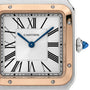Close-up of a Cartier Santos-Dumont watch face featuring Roman numerals, blue hands, and a gold and silver bezel.