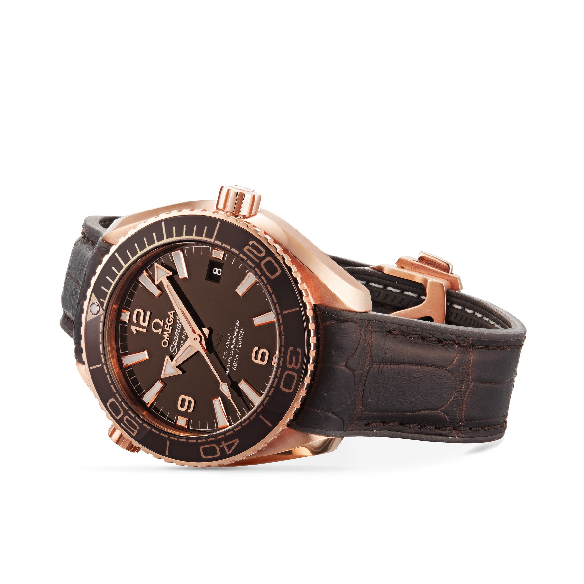 A rose gold OMEGA Seamaster Planet Ocean 600M wristwatch with a black dial, large numeral hour markers, date display, and brown leather strap is pictured against a white background.
