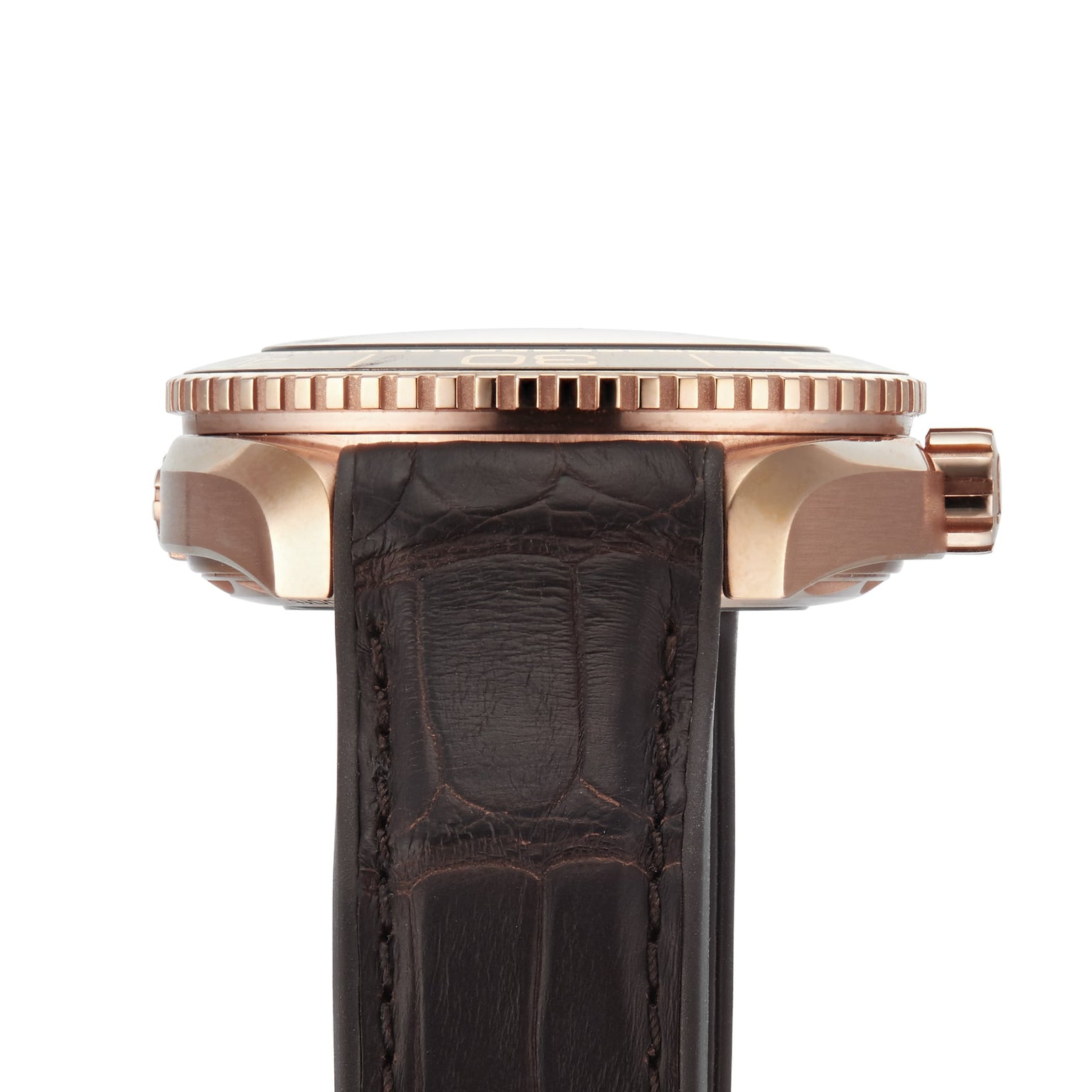 Side view of the OMEGA Seamaster Planet Ocean 600M with a rose gold case, textured bezel, crown, and a dark brown leather strap featuring visible stitching.