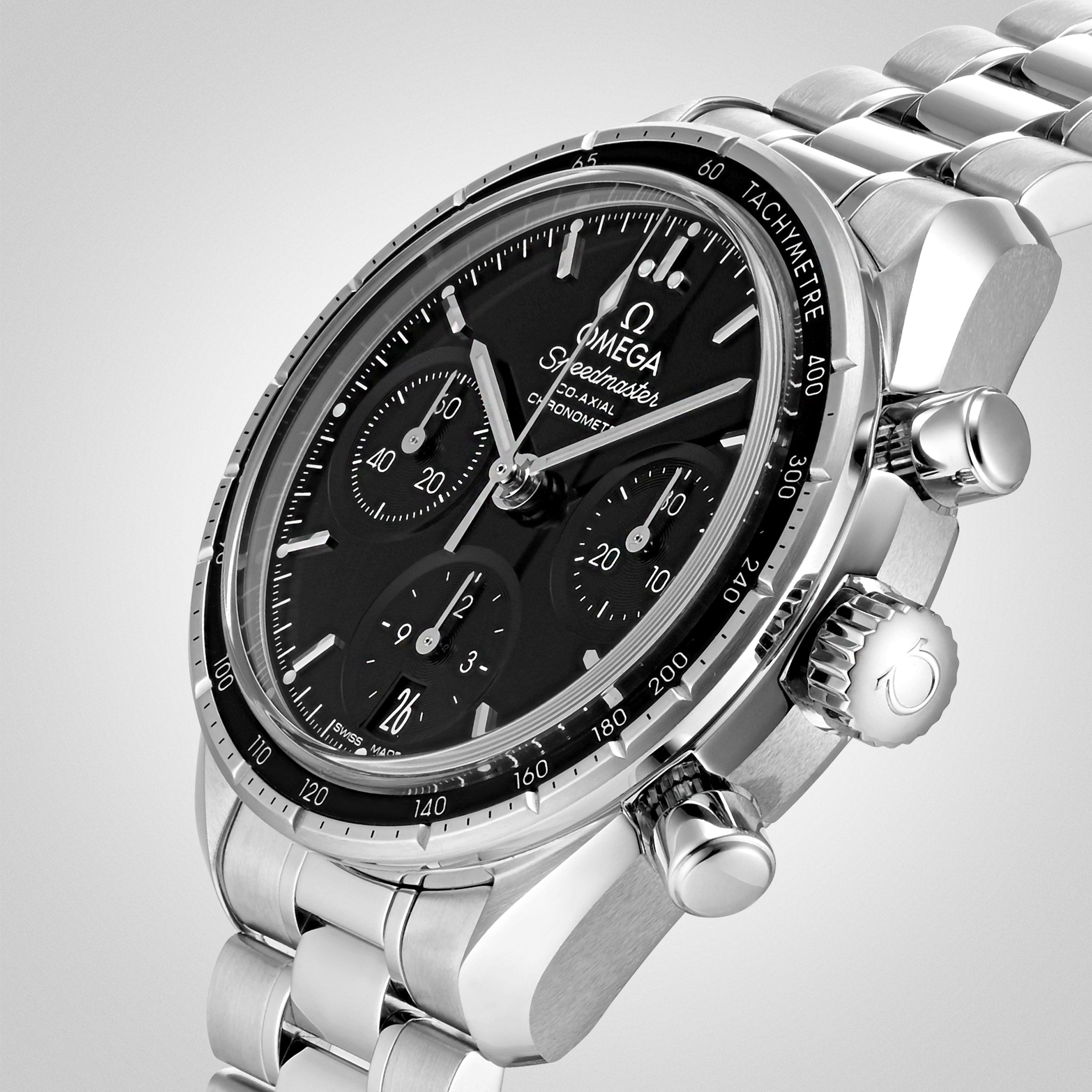 An OMEGA Speedmaster 38 watch in stainless steel with a black dial, tachymeter bezel, and three subdials, displayed on a silver metal bracelet—part of the acclaimed Speedmaster collection.