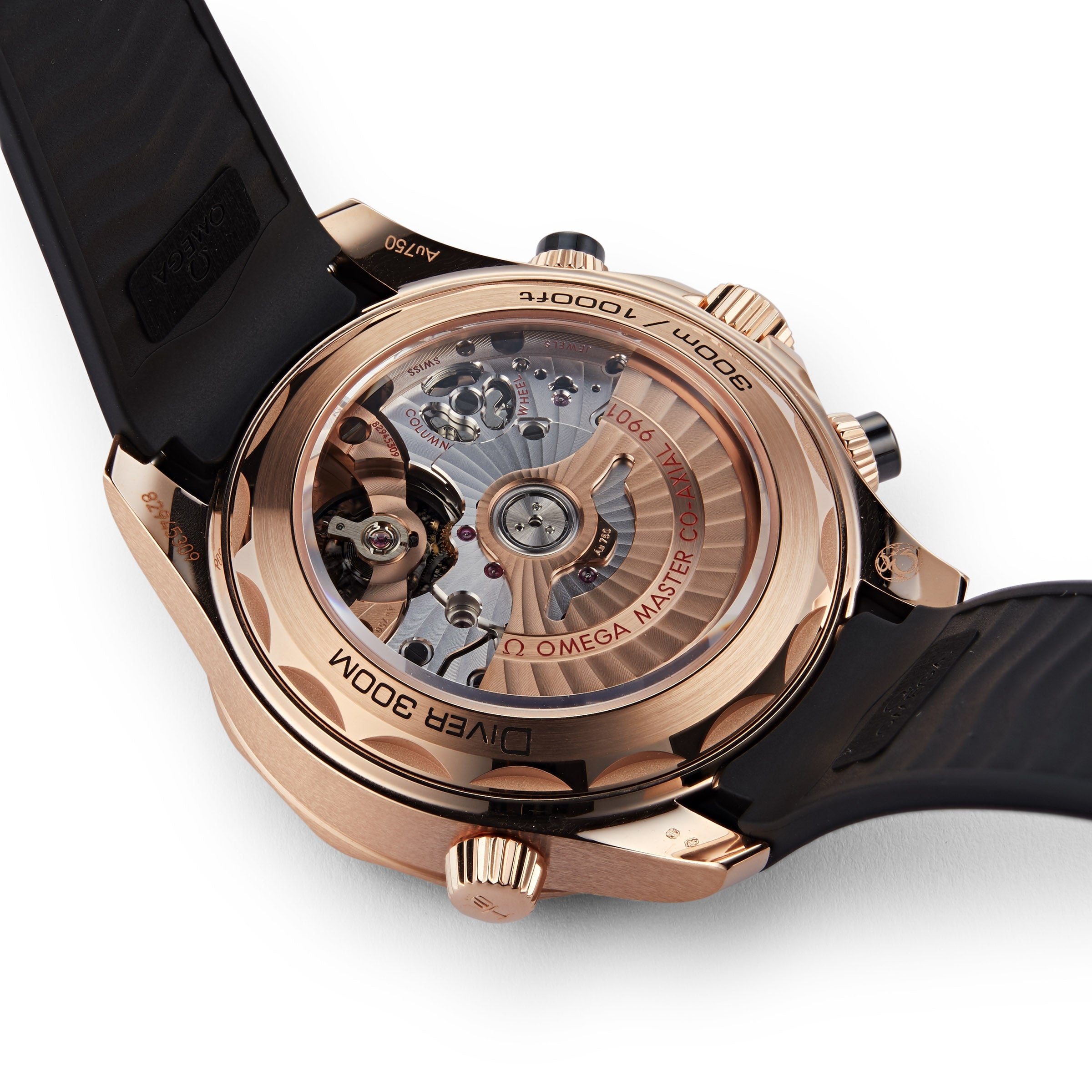 Close-up of the OMEGA Seamaster Diver 300Ms rose gold case back with a sapphire crystal revealing the mechanical movement, paired with a black rubber strap.