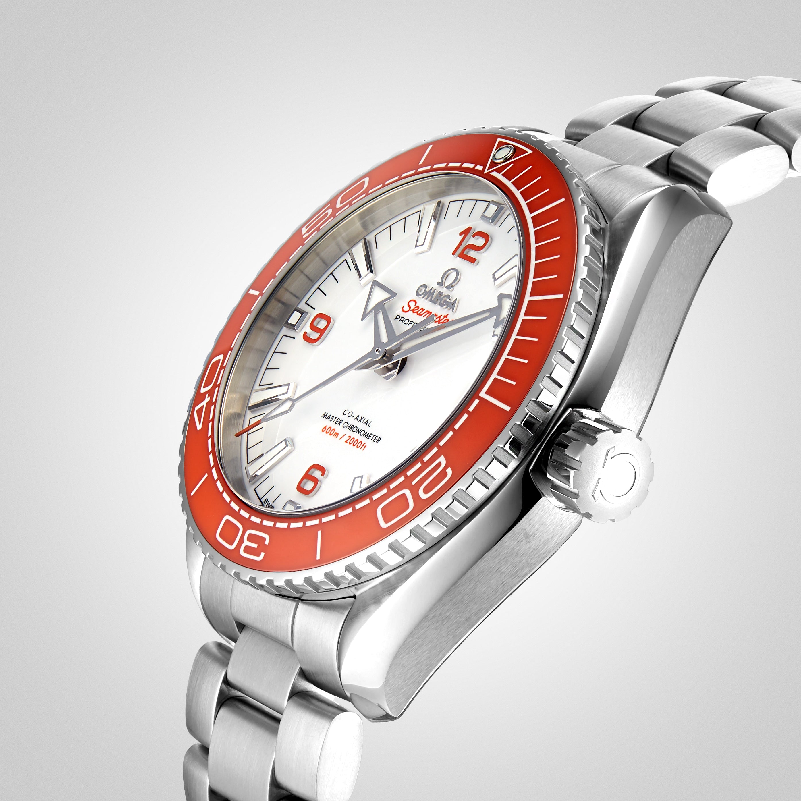 OMEGA Seamaster Planet Ocean 600M wristwatch featuring an orange bezel, white dial, and metal strap, shown at an angle on a light gray background.