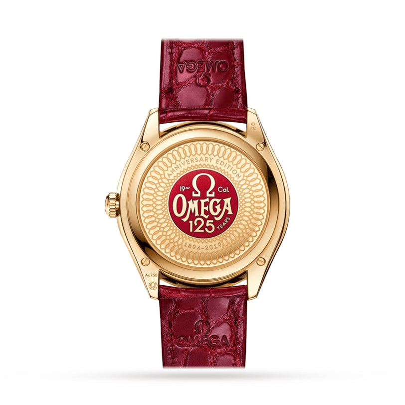 The back of an OMEGA De Ville Trésor wristwatch with a gold case and red leather strap features a 125th Anniversary Edition engraving in red and gold, and houses the Master Chronometer Calibre 8910.
