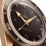 Close-up of the OMEGA Seamaster 300 watch, showcasing a black dial, gold hour markers and hands, a numbered rotating bezel, and a striking bronze gold case—a timepiece that exudes elegance and precision.