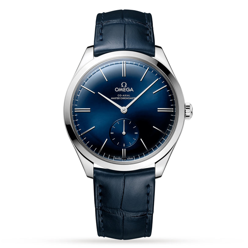 An OMEGA De Ville Trésor wristwatch with a stainless steel case, blue dial, small seconds subdial, and blue leather strap featuring the OMEGA Co-Axial Calibre 8926, shown on a white background.