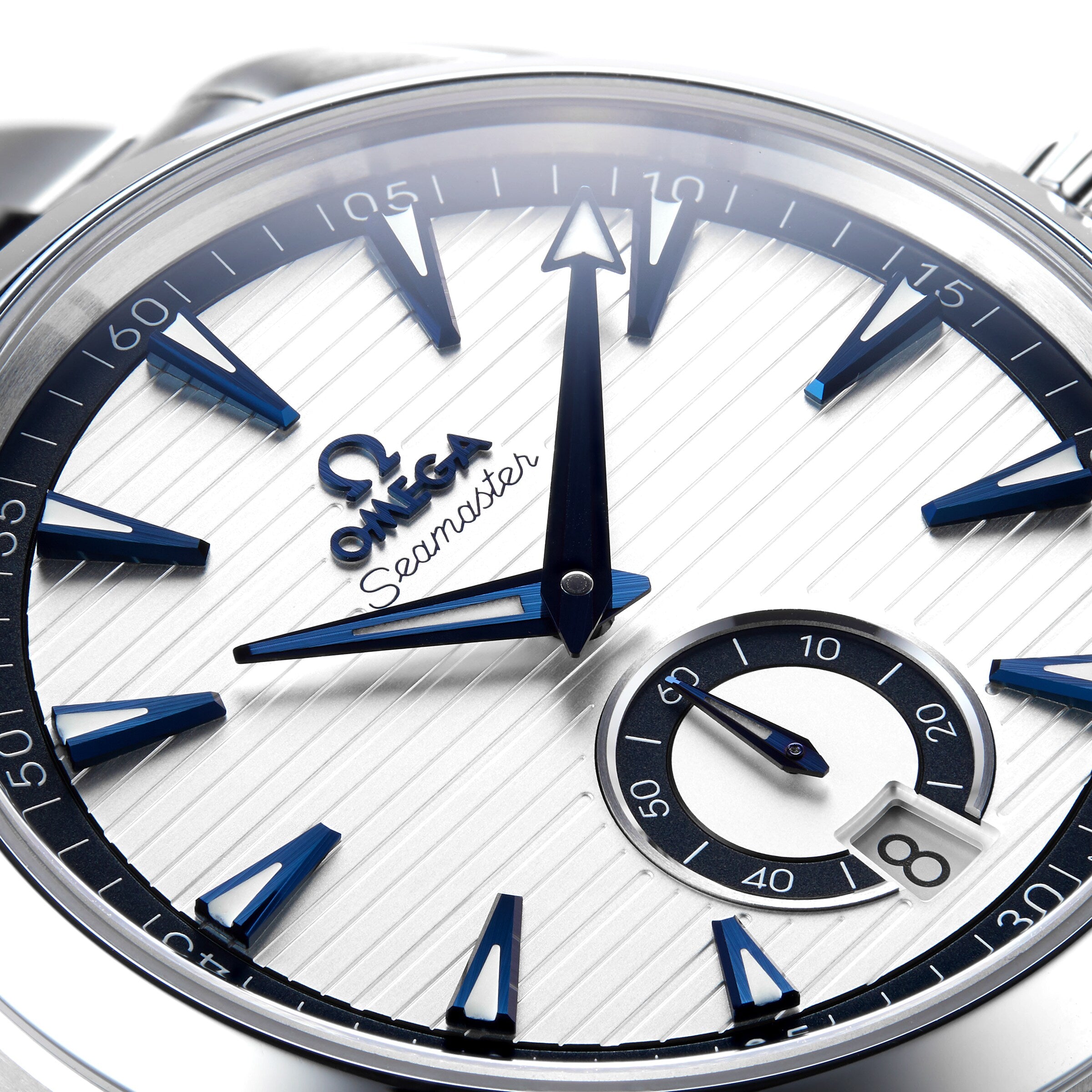 Close-up of the OMEGA Seamaster Aqua Terra 150M watch face at 12:00, featuring blue hands, hour markers, and a small seconds subdial at 6 o’clock—a striking nod to OMEGA’s maritime legacy.