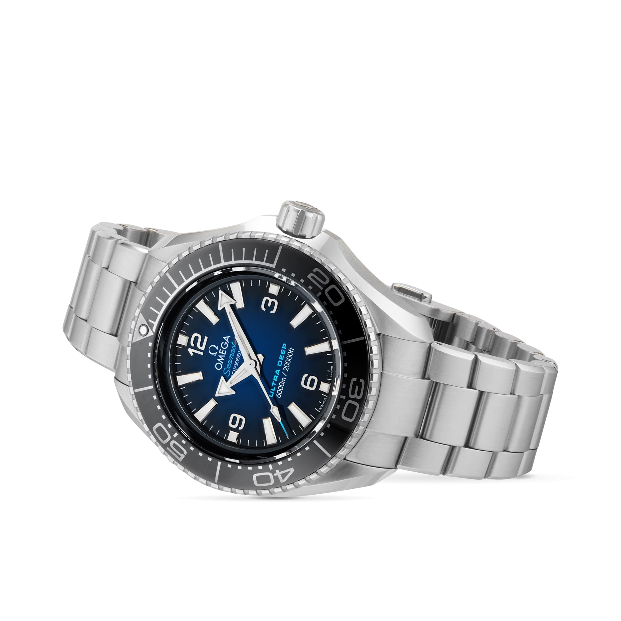 The OMEGA Seamaster Planet Ocean 6000M, a stainless steel wristwatch with a blue dial, black bezel, and silver bracelet, is shown against a white background—an exceptional choice inspired by saturation divers’ watches.