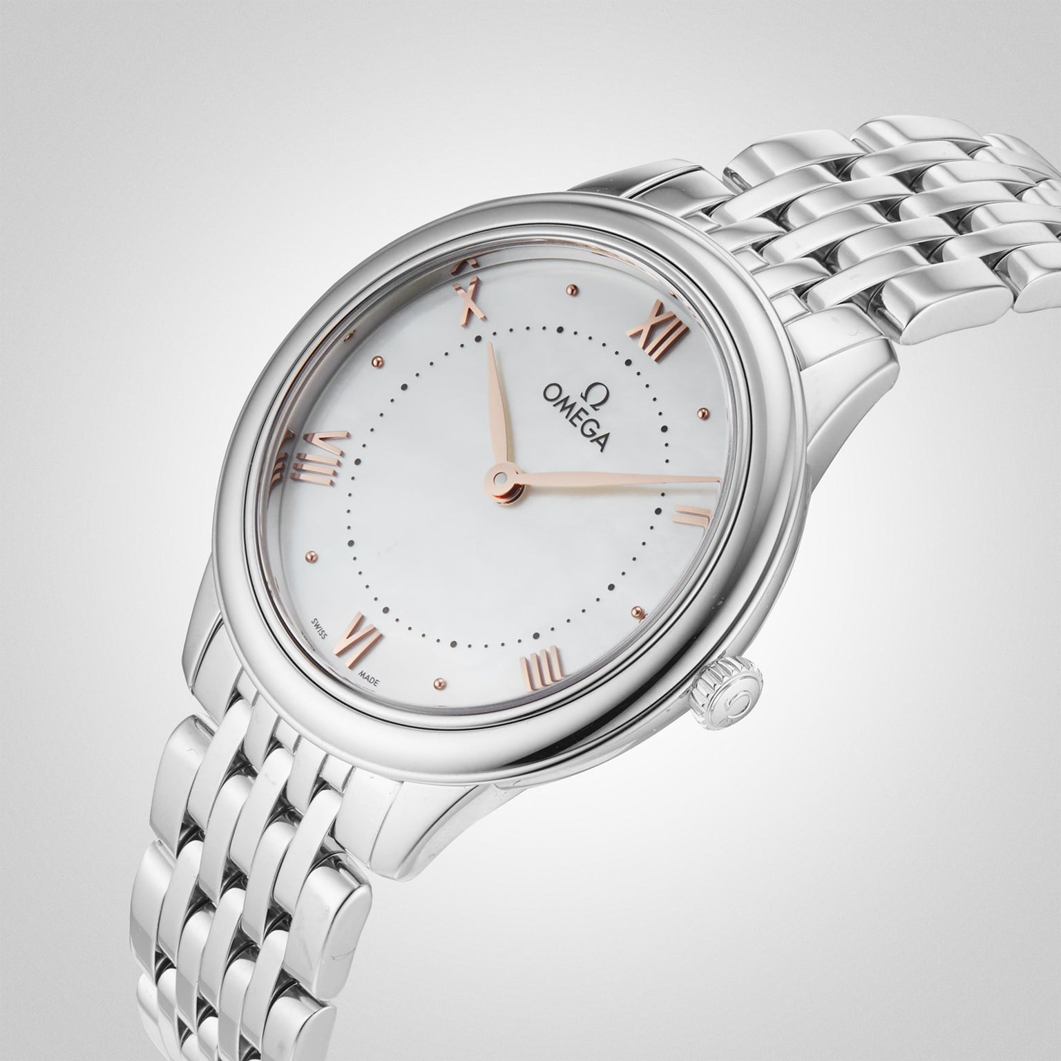 The OMEGA De Ville Prestige wristwatch, featuring a white dial, rose gold Roman numerals, and a silver metal link bracelet, radiates refined elegance against a soft gradient backdrop.