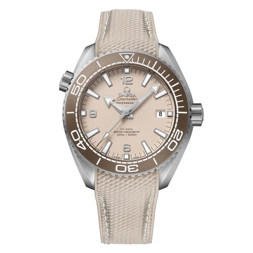 An OMEGA Seamaster Planet Ocean 600M dive watch with a beige textured strap, rotating bezel, date window at 3 o’clock, and luminous hands and markers is displayed on a white background.