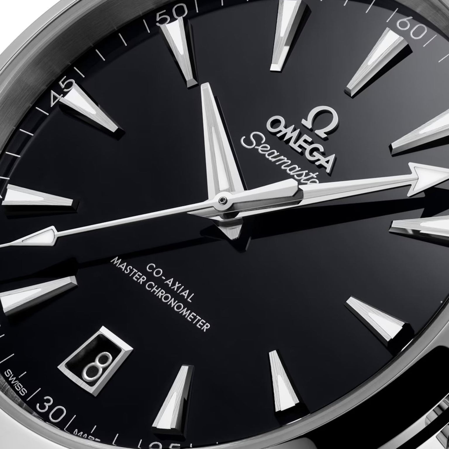 Close-up of an OMEGA Seamaster Aqua Terra 150M watch face, featuring silver hands, hour markers, a date window at 6 o’clock, and Co-Axial Master Chronometer inscriptions.