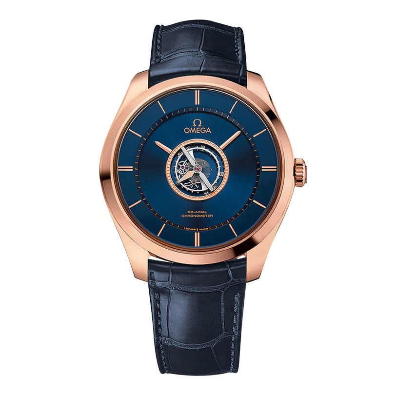 The OMEGA De Ville Tourbillon wristwatch features a blue dial, rose gold case, visible tourbillon, and blue leather strap, displayed against a white background.