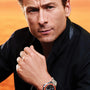Man wearing a watch with an orange background