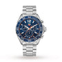 The TAG Heuer Formula 1 Chronograph features a stainless steel case, blue tachymeter bezel, quartz movement, three subdials, date display, and silver metal bracelet, displayed on a white background.