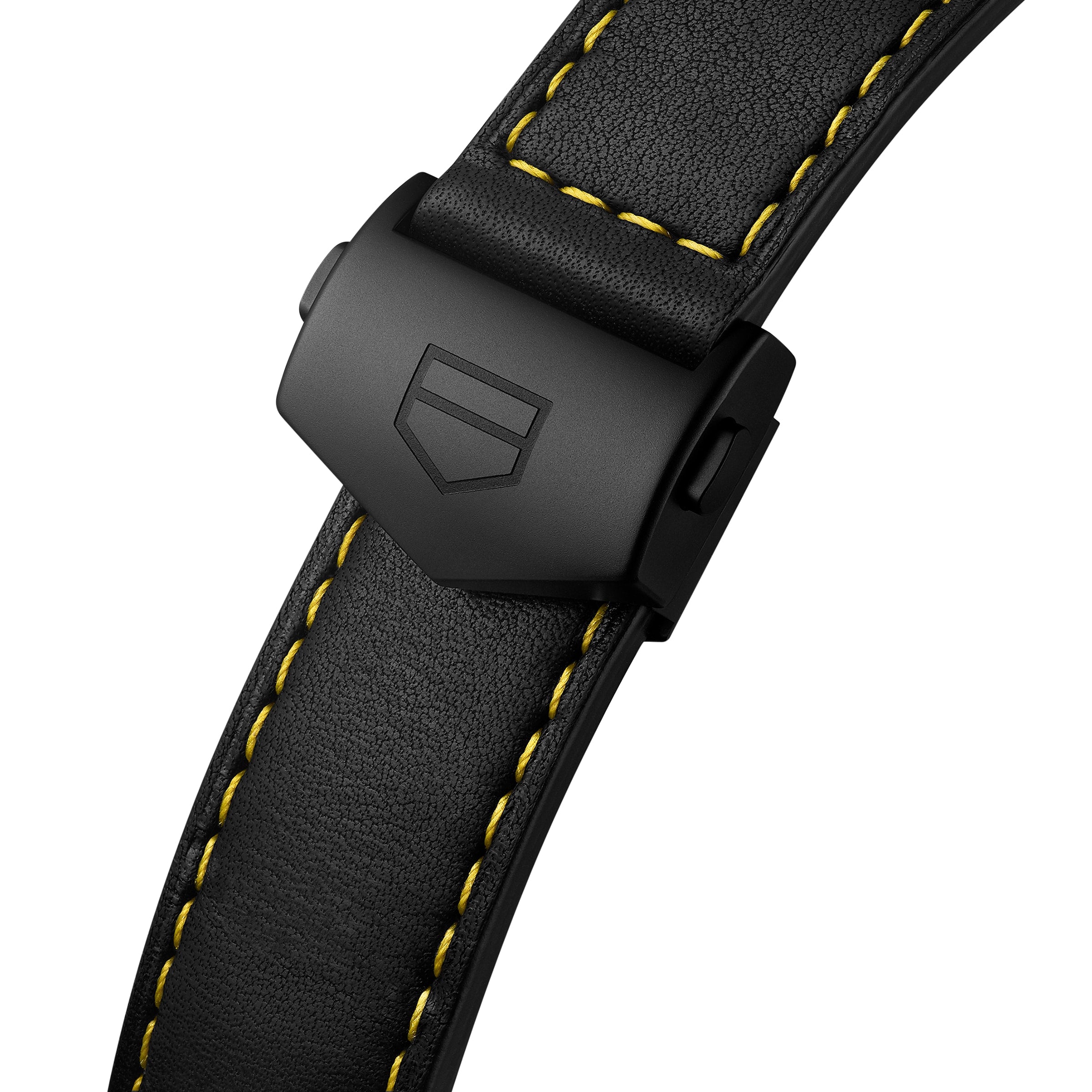 Close-up of a black watch strap with yellow stitching and matte black clasp, engraved with a geometric logo, designed for the TAG Heuer Special Edition Formula 1 Senna timepiece.