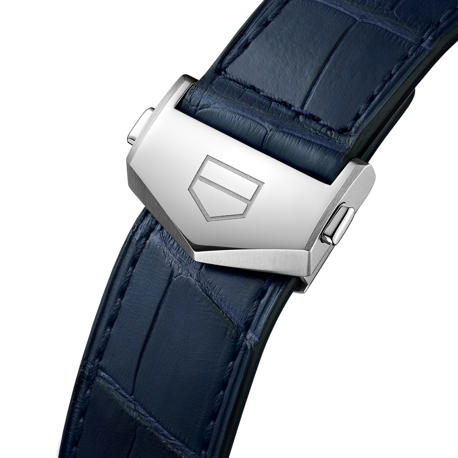 Close-up of a blue alligator leather strap with a silver clasp engraved with a geometric logo, highlighting the refined details of the TAG Heuer Carrera Day-Date timepiece.