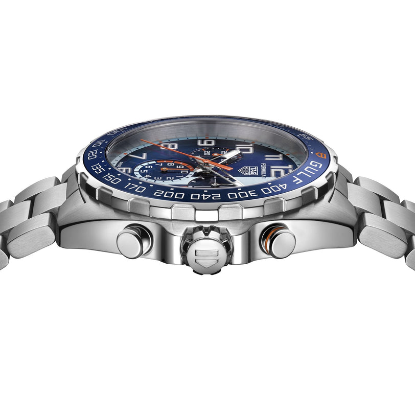 A close-up side view of the TAG Heuer Special Edition Formula 1 Chronograph X Gulf shows its stainless steel case, blue bezel, silver band, and side buttons, capturing the dynamic racing spirit of this striking timepiece.