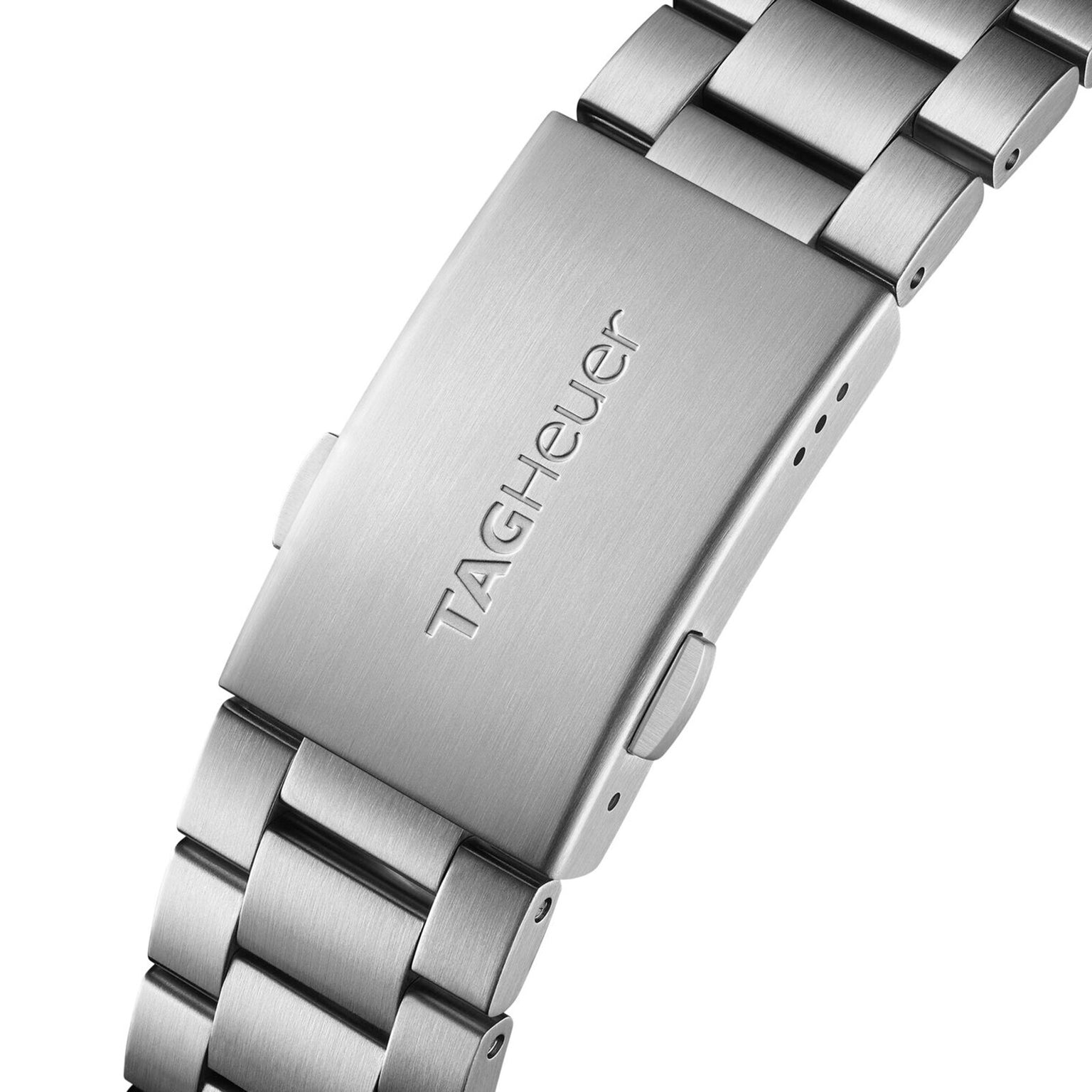 Close-up of a stainless steel TAG Heuer Special Edition Formula 1 X Indy 500 watch clasp with engraved logo on the metal bracelet.