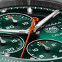 Close-up of a TAG Heuer Formula 1 Chronograph watch face showcasing green color, subdials, orange hands, prominent branding, and a striking green ceramic tachymeter bezel.