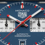 Monaco TAG Heuer chronograph watch face with blue dial, red and white hands, and subsidiary dials.