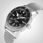 A Breitling Superocean Heritage B20 Automatic 46 watch with a black dial, date display, mesh bracelet, and 46mm stainless steel case is shown at an angle on a plain background.