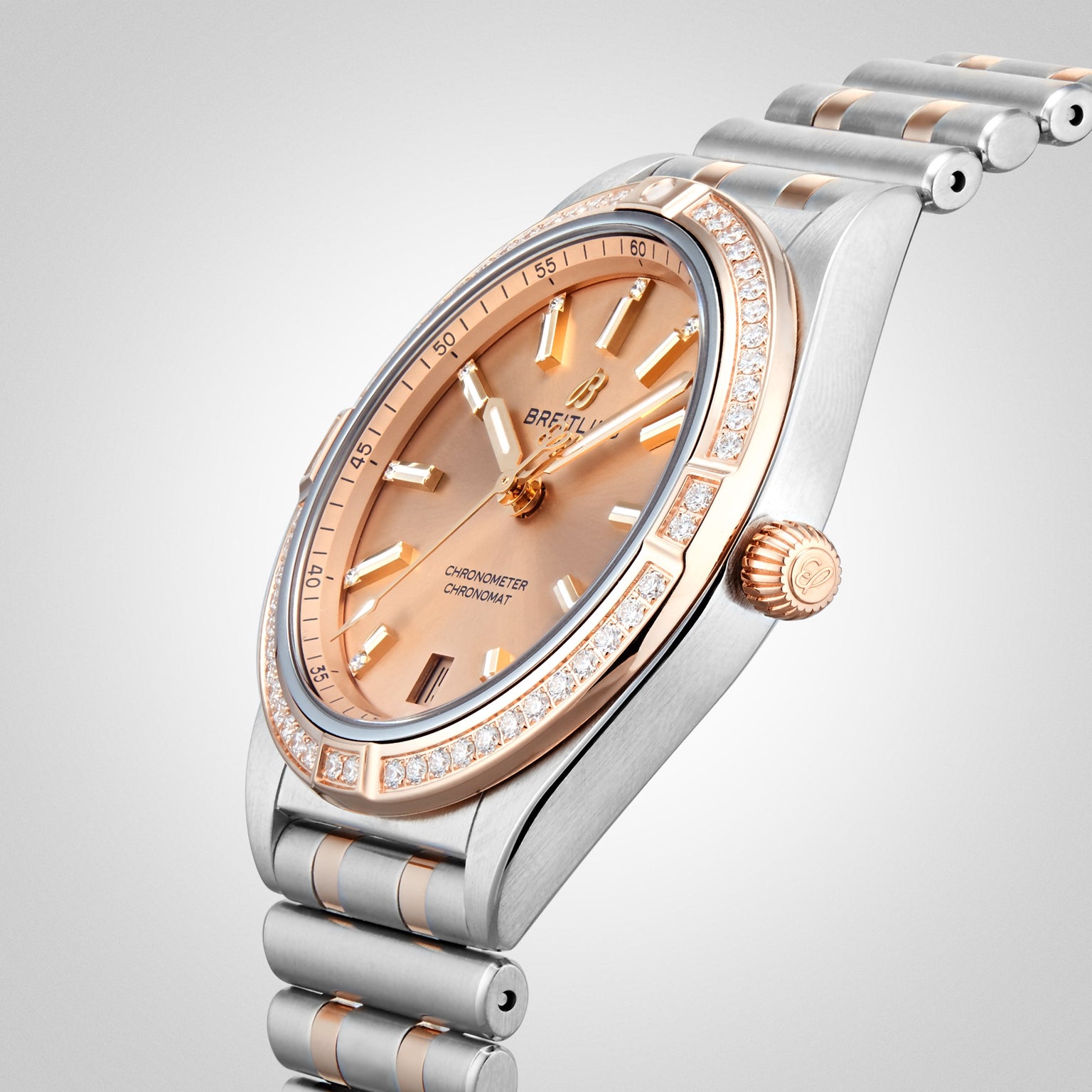 The Breitling Chronomat Automatic 36 is a luxury wristwatch featuring a rose gold and silver metal band, COSC-certified precision, diamond-set bezel, and a rose gold-tone dial.