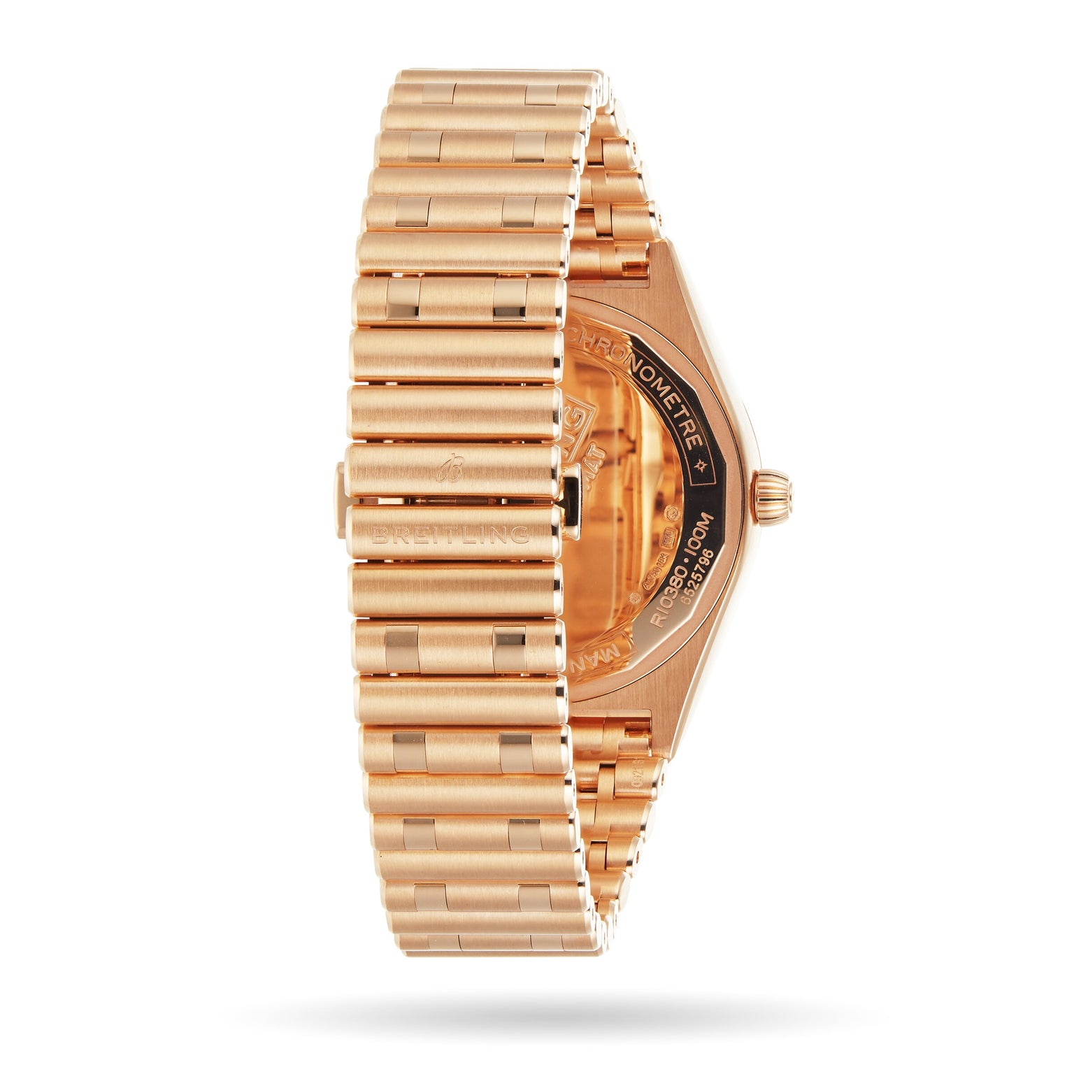 Side view of the Breitling Chronomat Automatic 36 watch in gold, showcasing its Rouleaux bracelet and a partially visible engraved case back.