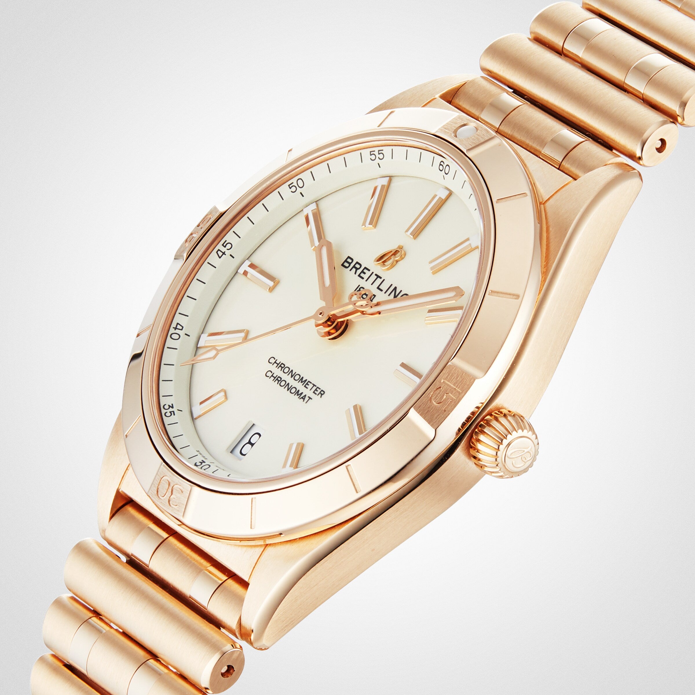 A Breitling Chronomat Automatic 36 wristwatch in gold, featuring a white dial with gold hour markers and hands, date window at 6 oclock, and a Rouleaux bracelet, displayed at an angle.