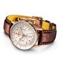 The Breitling Navitimer B01 Chronograph 41 features a gold case, cream dial, brown leather strap, three subdials, and date window; this iconic pilot’s watch is shown on a white background.
