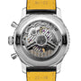 Close-up of the Breitling Navitimer B01 Chronograph 43, showing its exposed Breitling 01 calibre movement, labeled components, and a yellow leather strap with black edges.