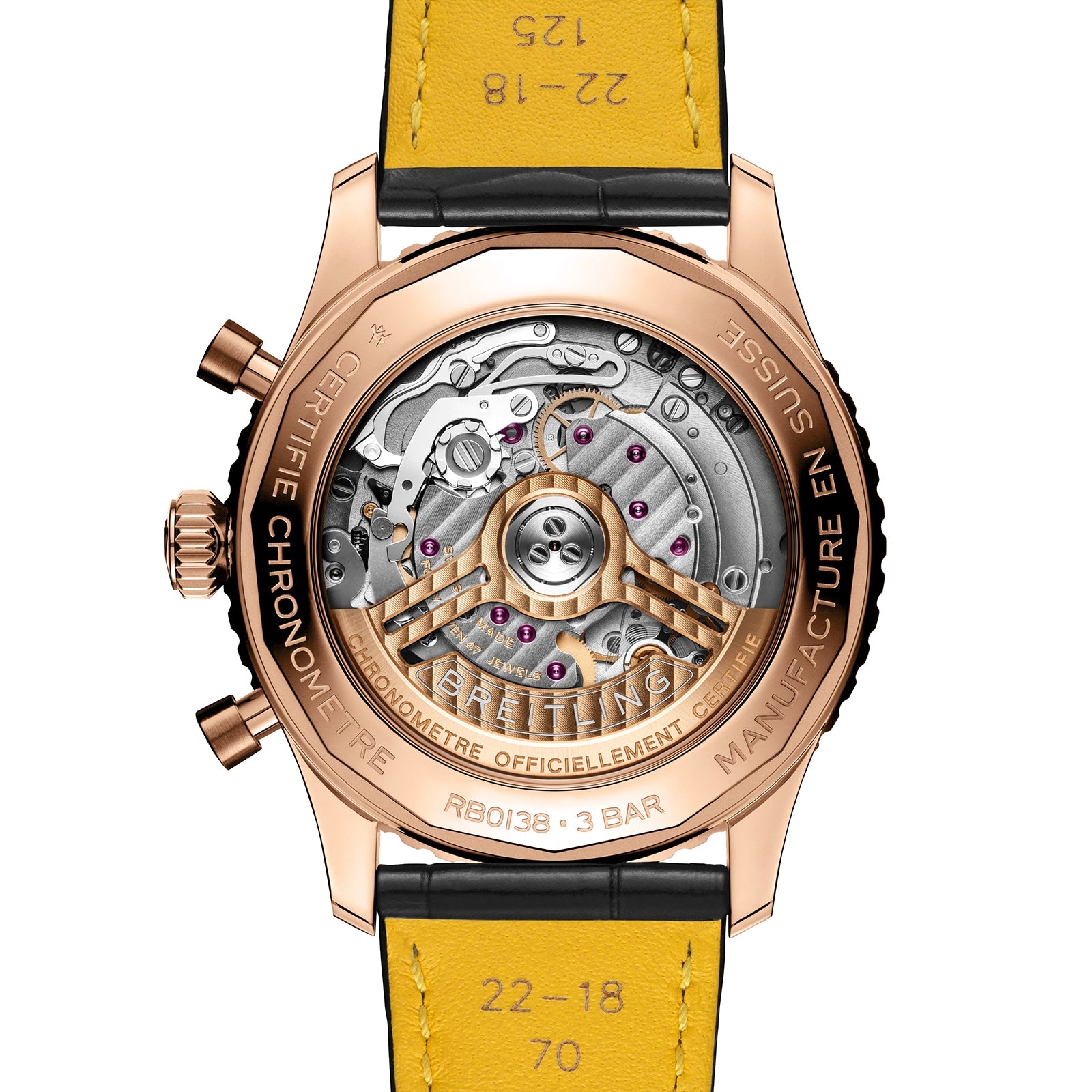 Close-up of the back of the Breitling Navitimer B01 Chronograph 43, highlighting its gold case, visible mechanical movement, engraved details, and yellow leather strap.