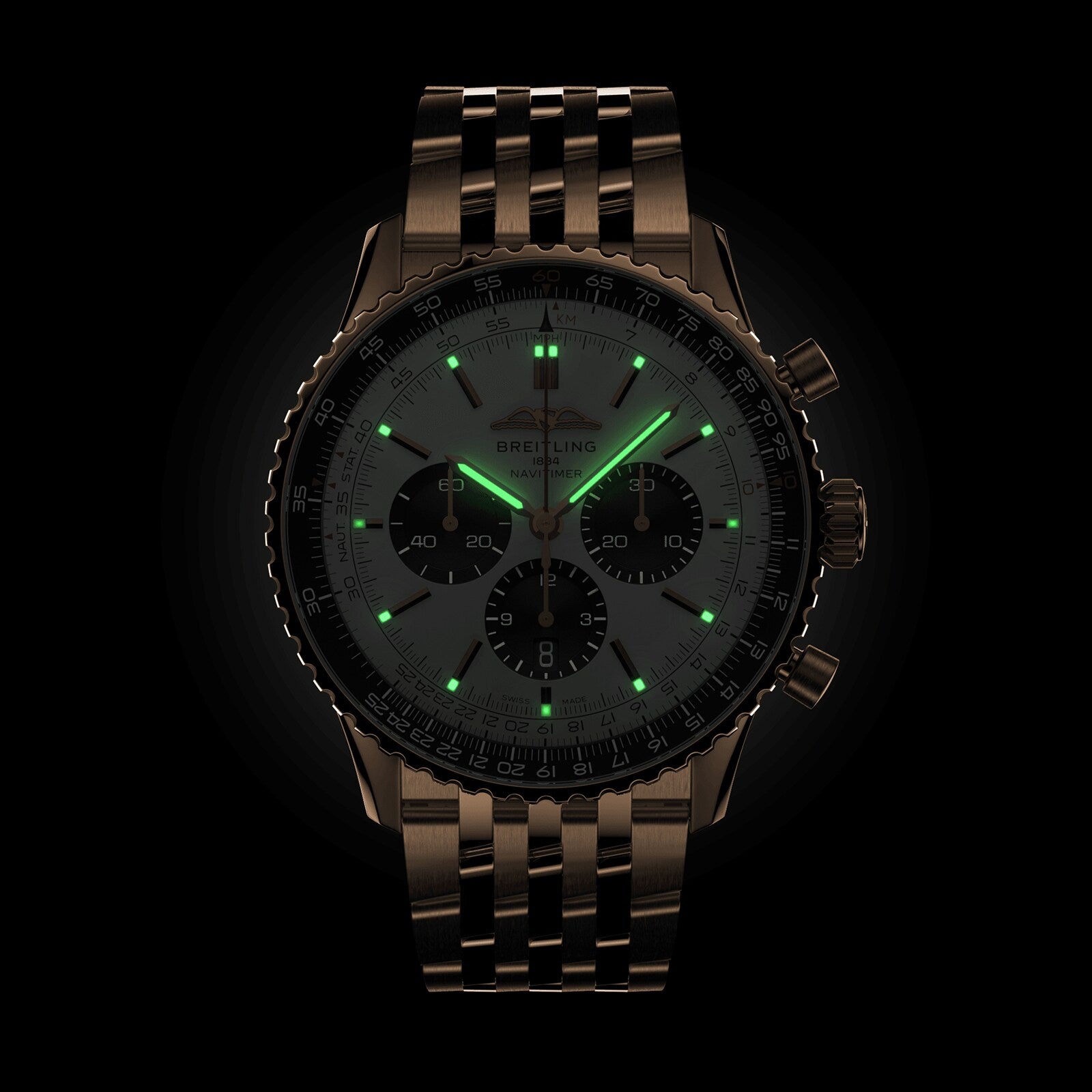 The Breitling Navitimer B01 Chronograph 46 is a metallic pilots watch with a round face and linked metal band, featuring faint green luminescent markers and hands for aviation-inspired style in the dark.