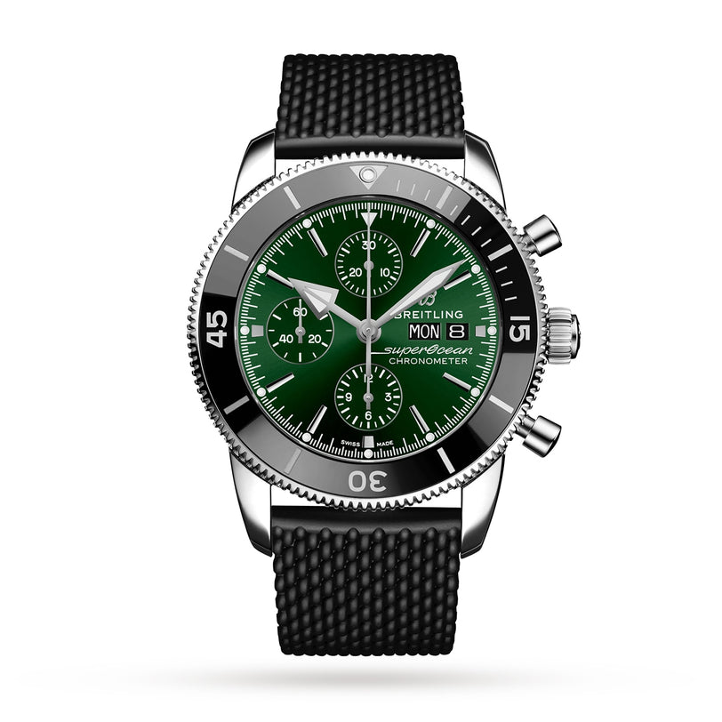 The Breitling Superocean Heritage Chronograph 44 is a stainless steel watch with a green dial, black bezel, three subdials, date display, textured black rubber strap, and water resistance, shown against a white background.