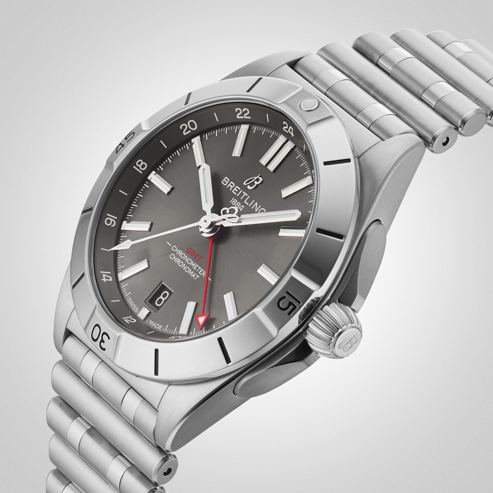 The Breitling Chronomat Automatic GMT 40 wristwatch features a stainless steel case, grey dial, date display, and a red-tipped GMT hand, displayed against a plain background.