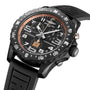 The Breitling Endurance Pro 44 IRONMAN® Finisher watch features a black dial, orange pulsometer scale, large white numerals, and a durable Breitlight® case with a black rubber strap.