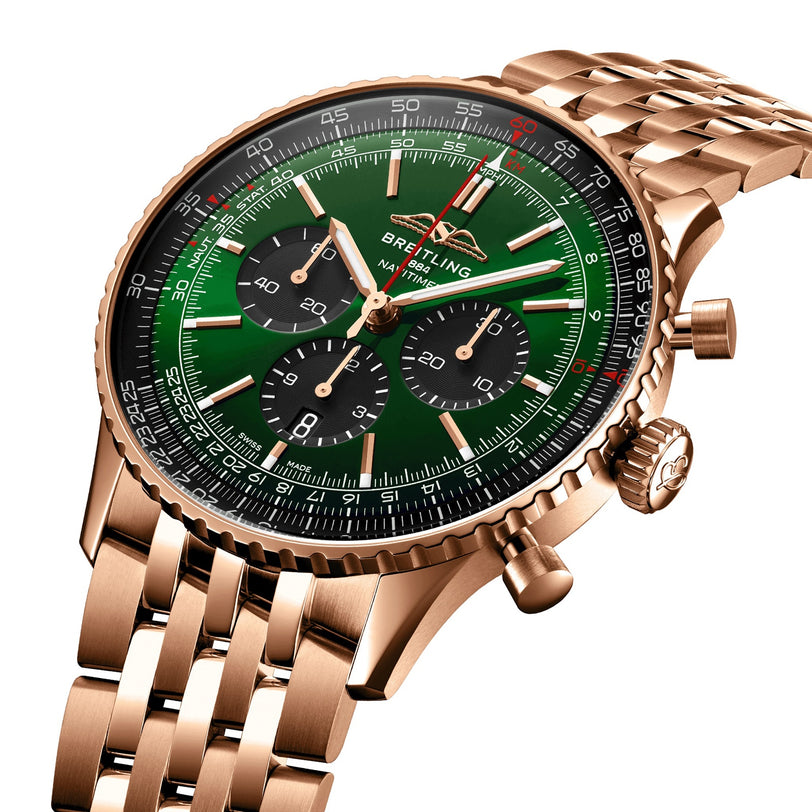 The Breitling Navitimer B01 Chronograph 46 features a gold case, green dial with three black subdials, and a gold link bracelet. This iconic watch is shown against a white background.