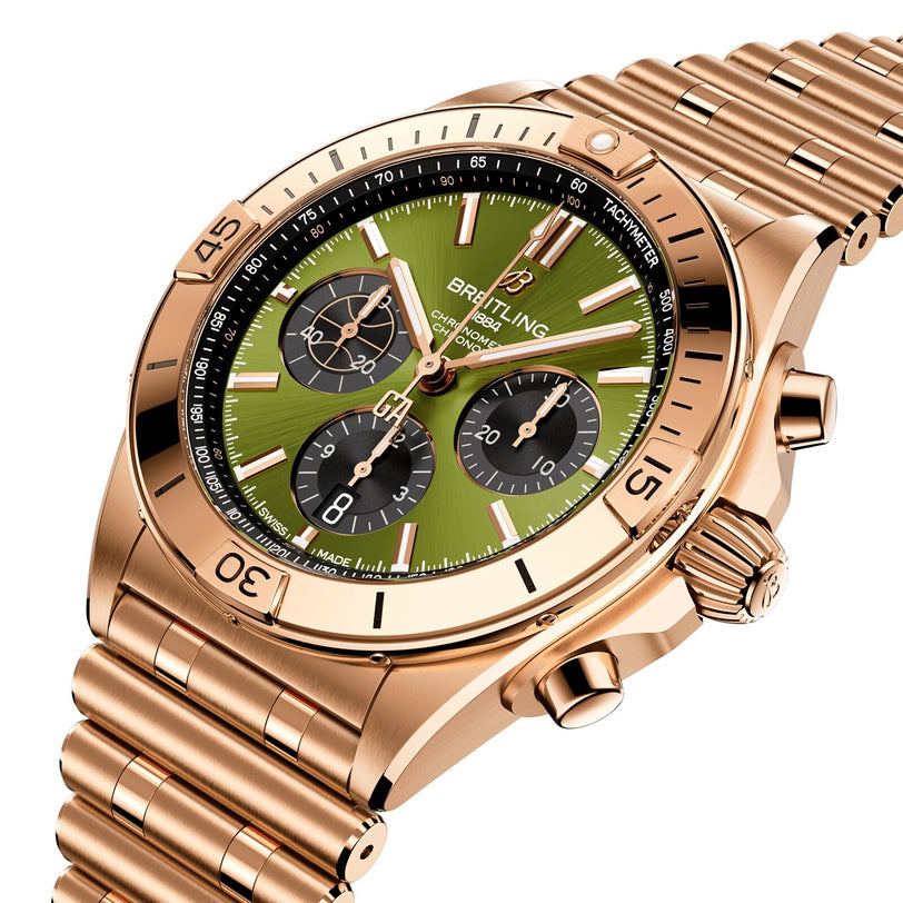 The Breitling Chronomat B01 42 Giannis Antetokounmpo is a limited edition gold chronograph wristwatch with a green dial, three subdials, date display, and link bracelet, displayed at an angle on a white background.