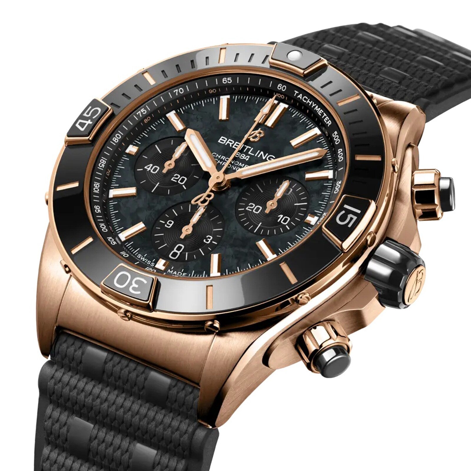 The Breitling Super Chronomat B01 44 is a gold wristwatch with a black textured strap, black bezel, and three subdials on a dark dial. COSC-certified, it combines precision and style in an angled display.