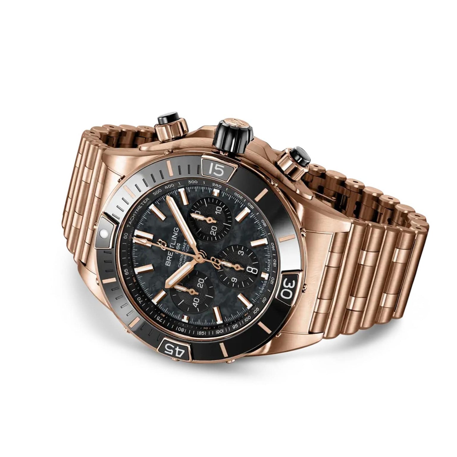 The Breitling Super Chronomat B01 44 features a rose gold case, black dial, and metal link bracelet, displayed at an angle.