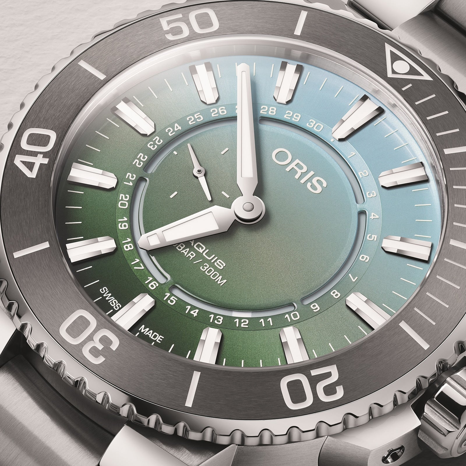 Close-up of the Oris Dat Watt Limited Edition II, featuring a green gradient dial inspired by the Wadden Sea, silver hour markers and hands, inner rim date scale, and a stainless steel diving bezel.