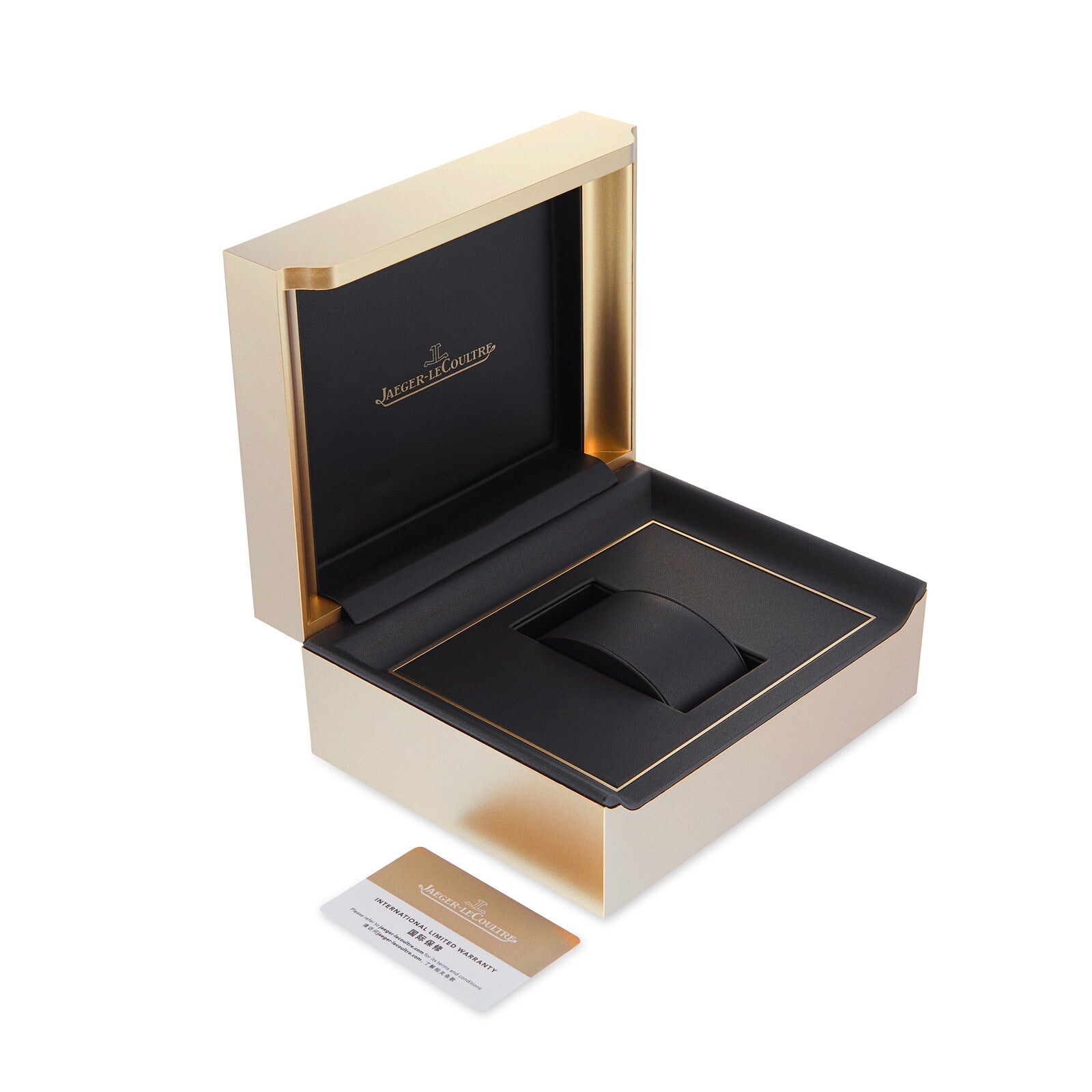 An open Jaeger-LeCoultre watch box in gold and black reveals a cushioned slot for the Master Ultra Thin Date. The brand’s logo appears inside the lid, with a card featuring gold accents placed next to the box.