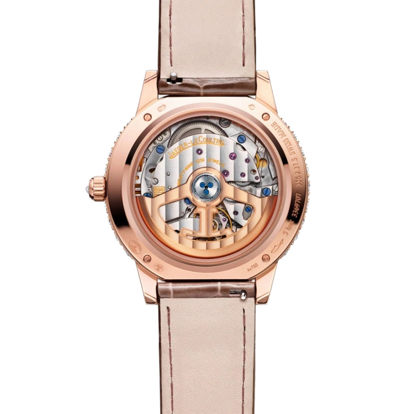 The back view of the Jaeger-LeCoultre Rendez-Vous Night & Day features a beige leather strap and rose gold case, showcasing intricate mechanical gears through its transparent caseback.