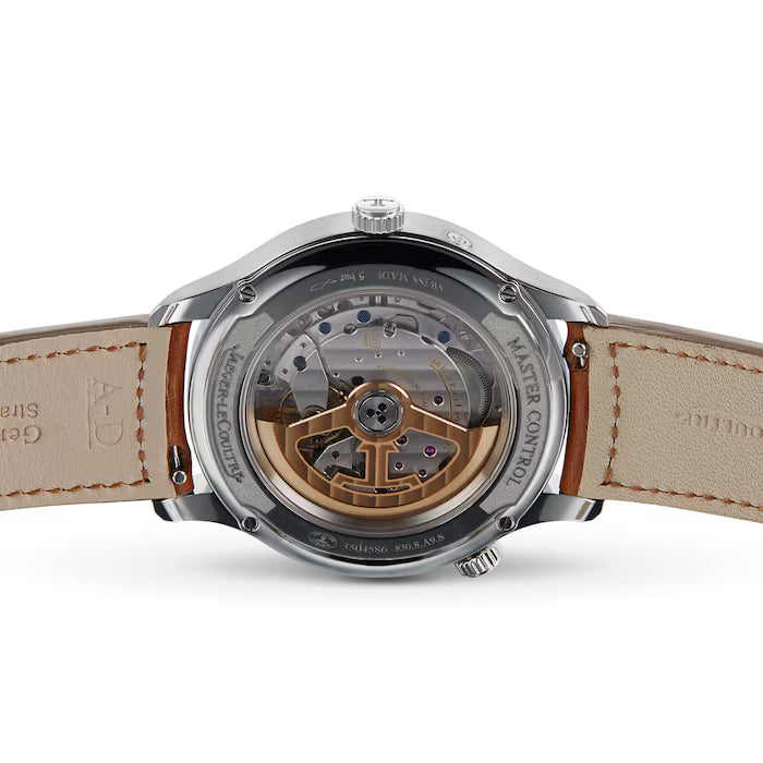 Close-up of the back of a Jaeger-LeCoultre Master watch in stainless steel, featuring a transparent case showing off the intricate mechanical movement, visible leather strap, and engraved rim markings.